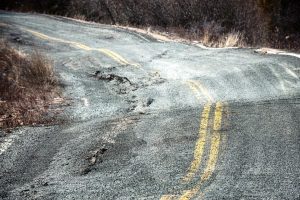 road warped by thawing permafrost